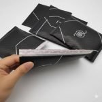 A stack of custom logo printed **poly bubble mailer** bags in various colors, ready for shipping.