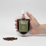A custom printed frosted **cold brew spout pouch** standing upright, filled with dark coffee concentrate.