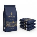 A stack of 25kg **pp woven rice bag**s with colorful BOPP printing and handles, filled with grains.