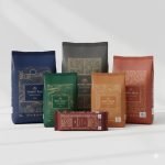 A stack of 25kg **pp woven rice bag**s with colorful BOPP printing and handles, filled with grains.
