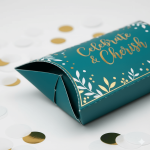 A small brown kraft **pillow box** with gold foil stamping, used for wedding candy favors.