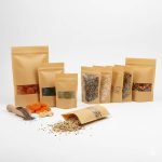 A stand-up **compostable kraft paper bag** with a clear window, filled with organic granola.