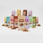 A custom **digital printed pouch** with vibrant coffee bean graphics, standing on a wooden surface.