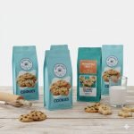 A custom **digital printed pouch** with vibrant coffee bean graphics, standing on a wooden surface.
