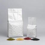 A silver aluminum foil **vacuum brick bag** filled with ground coffee, showcasing its compact side gusset shape.