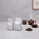 A silver aluminum foil **vacuum brick bag** filled with ground coffee, showcasing its compact side gusset shape.