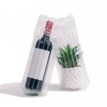 An inflated clear **air column bag** protecting a glass wine bottle for safe shipping.