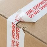 A roll of custom water activated packing tape with a black logo printed on natural kraft paper.