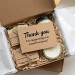 A group of personalized modern package insert cards with gold foil logos on a textured paper background.