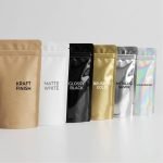 A black smell proof bag with a matte finish and a gold custom logo on a wooden background.