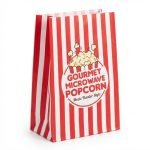 A microwavable popcorn bag showing the internal susceptor patch and freshly popped popcorn coming out.