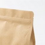 A brown kraft paper stand up pouch with window filled with granola and sealed with a zipper.