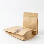 A brown kraft paper stand up pouch with window filled with granola and sealed with a zipper.