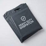 A blue poly mailer with handle featuring a custom white logo and being carried by its die-cut handle.