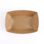A disposable kraft paper boat tray filled with golden french fries and a hot dog.