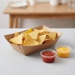 A disposable kraft paper boat tray filled with golden french fries and a hot dog.