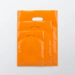 die cut handle plastic bags showing prismatic rainbow effect on transparent soft BOPP base
