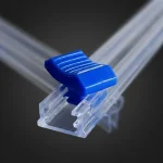 Close-up of slider zipper sealing strip surface with vertical holographic grating pattern