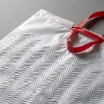 Close-up of drawstring plastic garbage bags surface with vertical holographic grating pattern