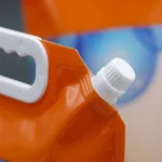 Close-up of stand up spout pouch with handle surface with vertical holographic grating pattern